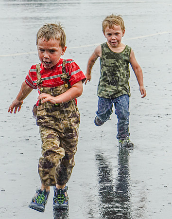 Twins Running in the Rain